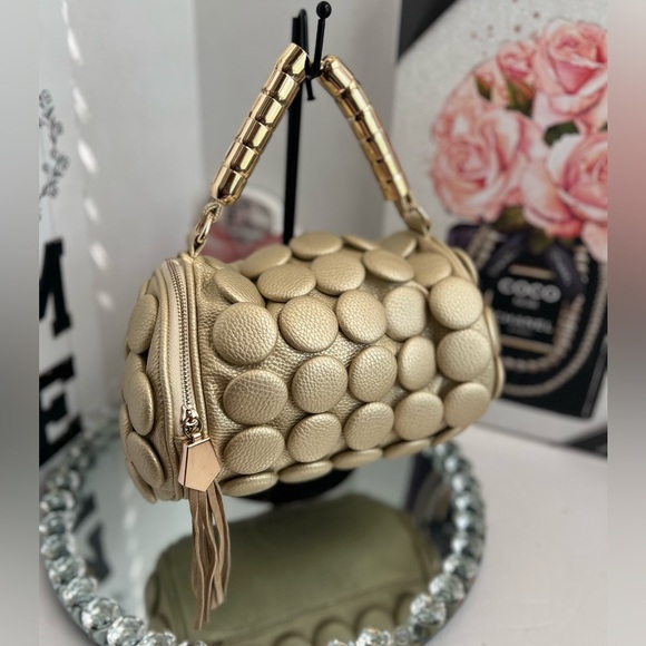 unique design with embossed circular details and a structured, metallic handle. - Picture 3 of 12